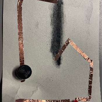 Graphite used as the circuit conductor. I found it did not really work that well and only worked at very specifc angles based off the battery position