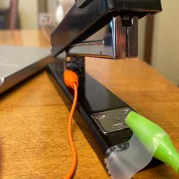Another image of how the stapler circuit was setup and how it functions. The aligator clip is taped in place making sure it does not fall off when the interaction happens. 