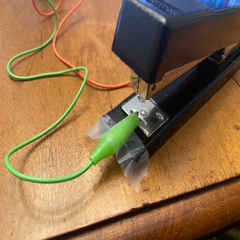 I setup a circuit with a stapler. The interaction makes the stapler the button so on press the two points would connect completing the circuit and giving a visual to the user on the screen.  